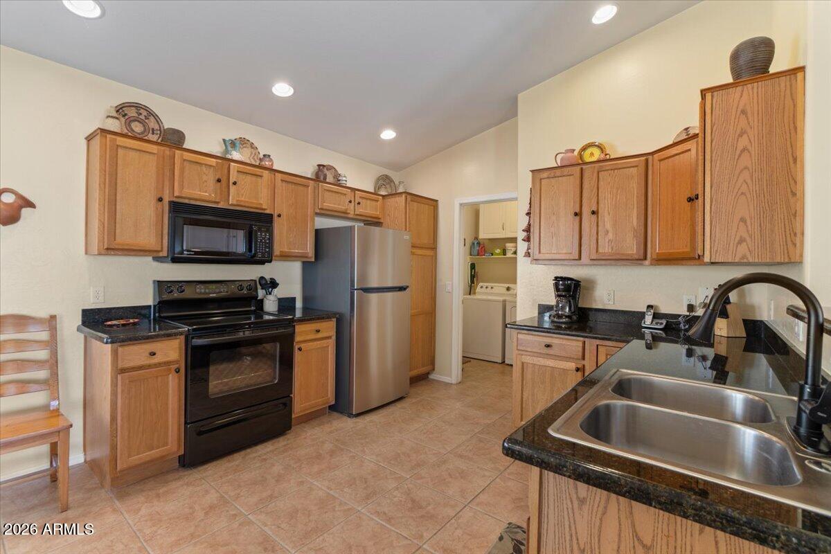 14234 South Capistrano Road Arizona City, AZ 85123 - Photo 9 of 42 a kitchen with refrigerator a stove a sink and a microwave oven with wooden floor