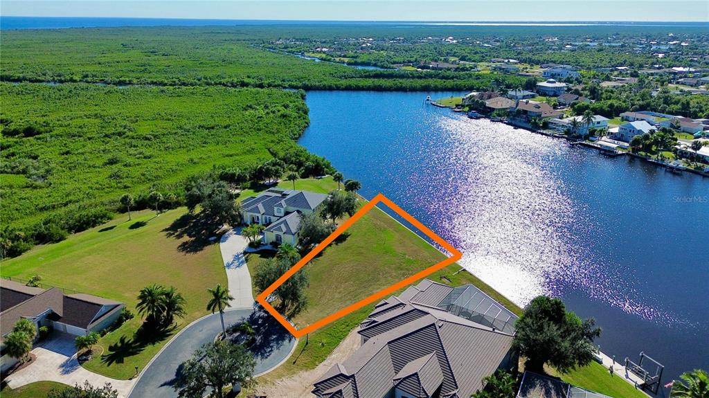 4361 Point Court Port Charlotte, FL 33948 - Photo 2 of 26 an aerial view of lake and residential houses with outdoor space