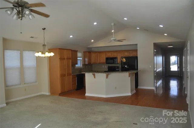 a view of a living room a kitchen and a refrigerator