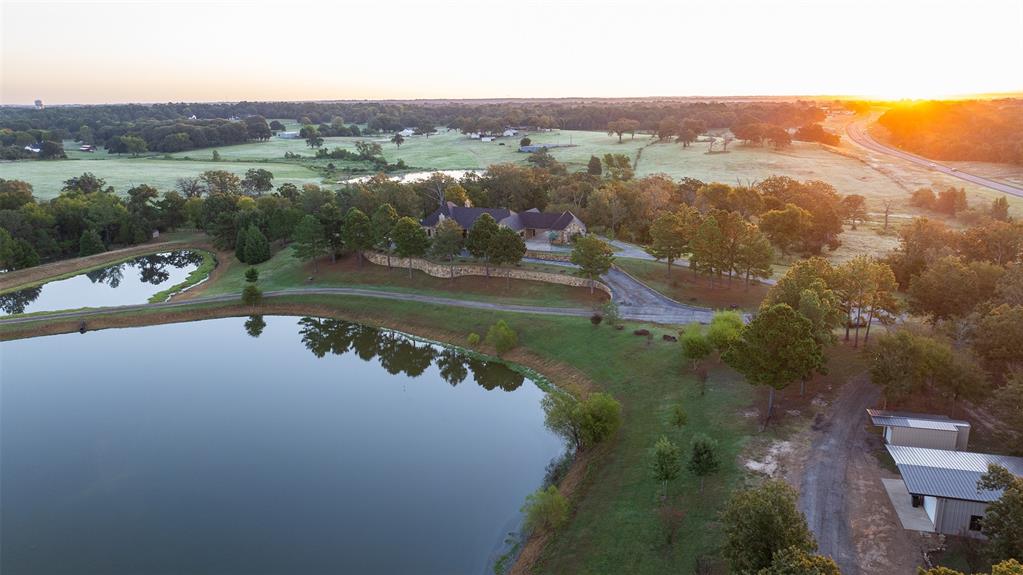 an aerial view of a house with a lake view