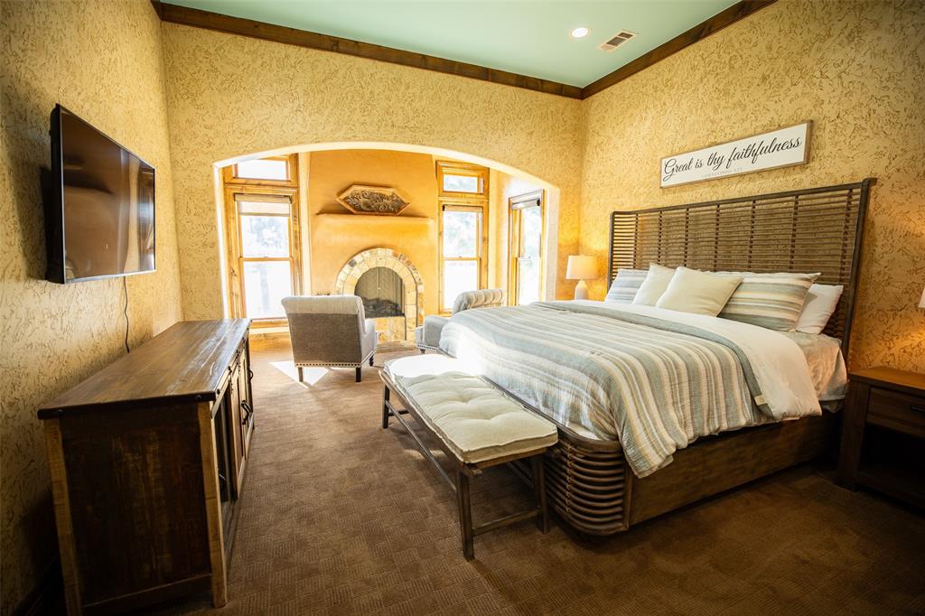 450 Northeast Loop 7 Athens, TX 75751 - Photo 5 of 38 a spacious bedroom with a bed and a flat screen tv