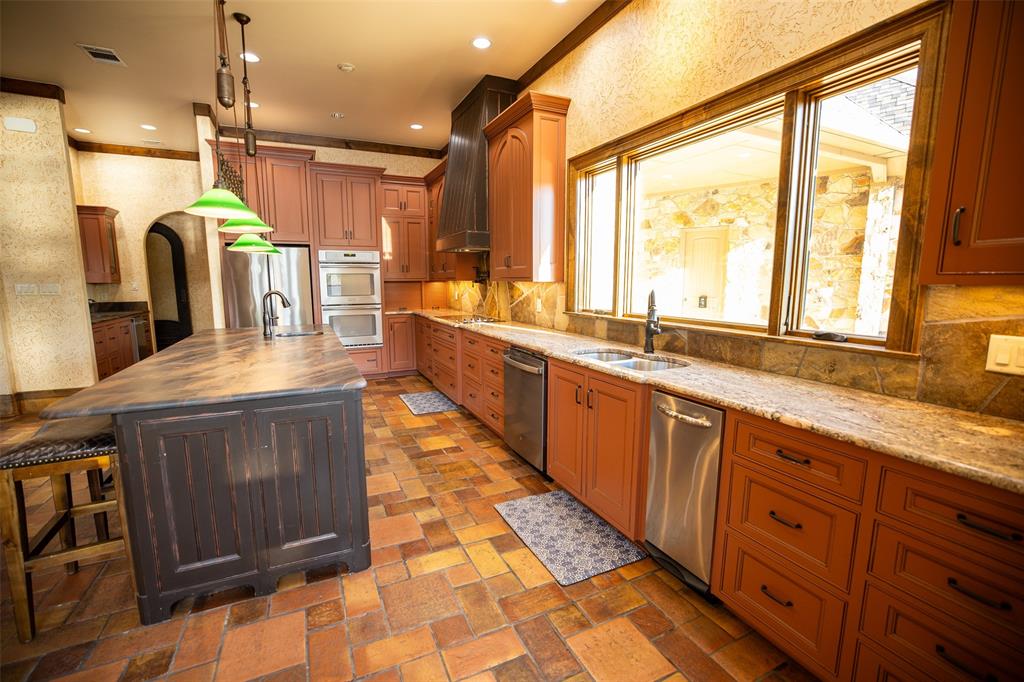 450 Northeast Loop 7 Athens, TX 75751 - Photo 6 of 38 a large kitchen with kitchen island granite countertop a large window and a sink