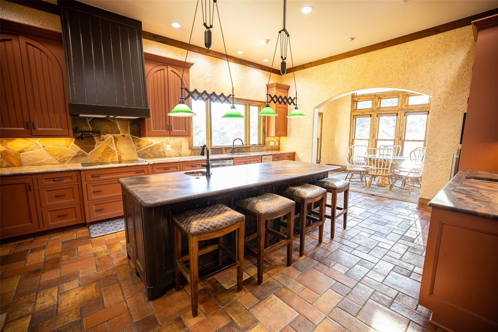 450 Northeast Loop 7 Athens, TX 75751 - Photo 8 of 38 a kitchen with granite countertop a sink a counter top space and cabinets