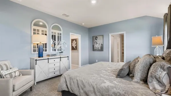 a bedroom with a bed and a chandelier