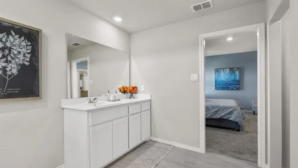 a en suite bathroom with a sink and a mirror
