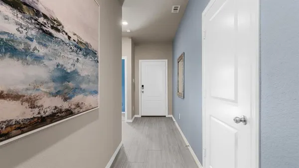 a bedroom with a bed and painting on the wall