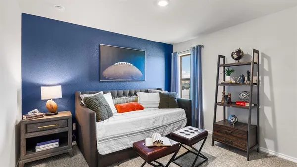 a bedroom with a bed and the view of hallway