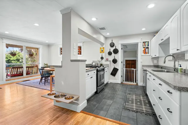 a kitchen with stainless steel appliances granite countertop a refrigerator and a stove top oven