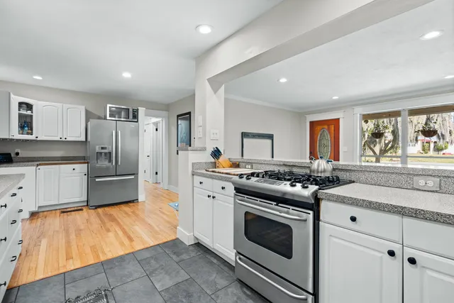 a kitchen with stainless steel appliances granite countertop a stove and a refrigerator