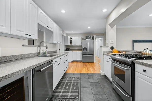 a kitchen with granite countertop stainless steel appliances and wooden cabinets
