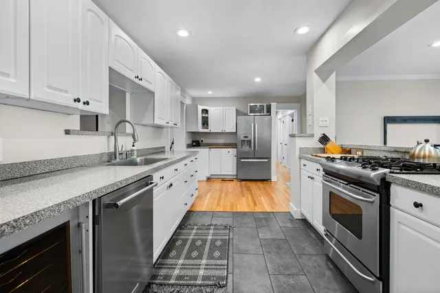 a kitchen with granite countertop stainless steel appliances and wooden cabinets