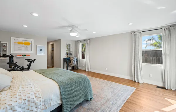 a bedroom with a large bed and a window