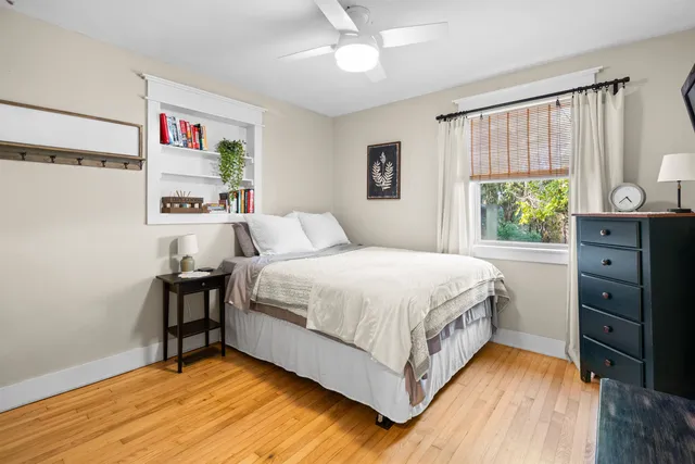 a bedroom with a bed and a window