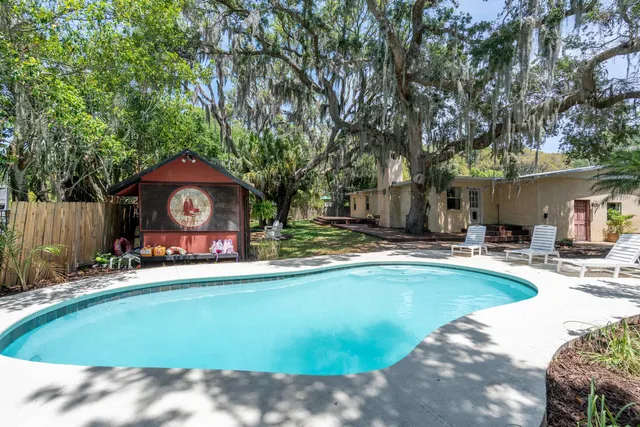 a swimming pool with outdoor seating and yard