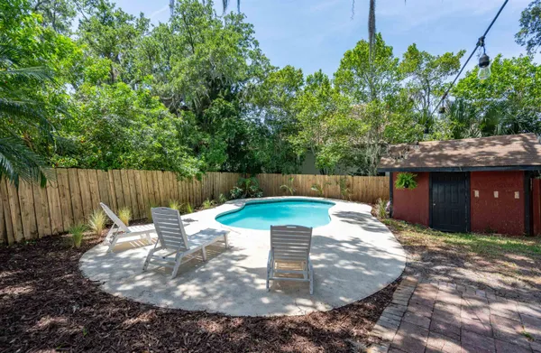 a backyard of a house with table and chairs