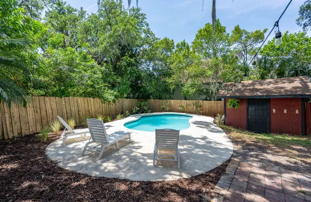 a backyard of a house with table and chairs