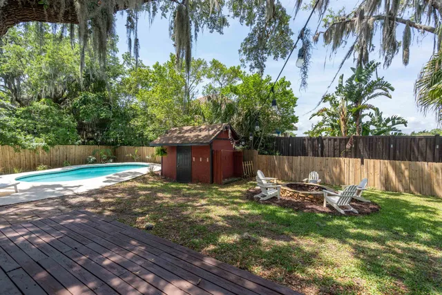a view of backyard with table and chairs and a barbeque