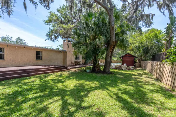 a backyard of a house with table and chairs