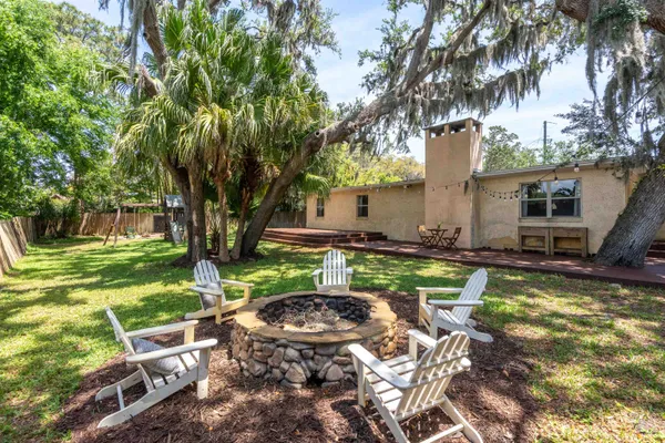 a swimming pool with outdoor seating and yard