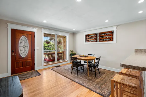 a view of a dining room with furniture window and wooden floor