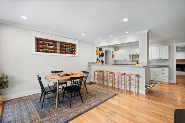 a view of a dining room with furniture and wooden floor