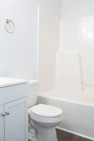 a bathroom with a toilet a sink and bathtub