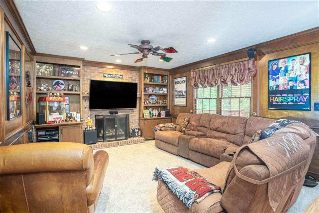 3838 Hunting Ridge Drive Southwest Lilburn, GA 30047 - Photo 12 of 56 a living room with furniture a large window and a flat screen tv