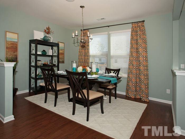 3003 Bluegrove Road Raleigh, NC 27610 - Photo 4 of 25 a dining room with furniture window and wooden floor