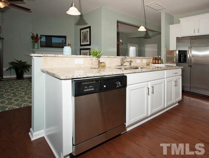 3003 Bluegrove Road Raleigh, NC 27610 - Photo 8 of 25 a kitchen with stainless steel appliances granite countertop a sink and a refrigerator