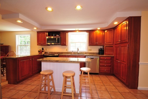 29 Johnson Road Sutton, MA 01590 - Photo 6 of 29 a kitchen with stainless steel appliances granite countertop wooden cabinets a sink a stove a dining table and chairs