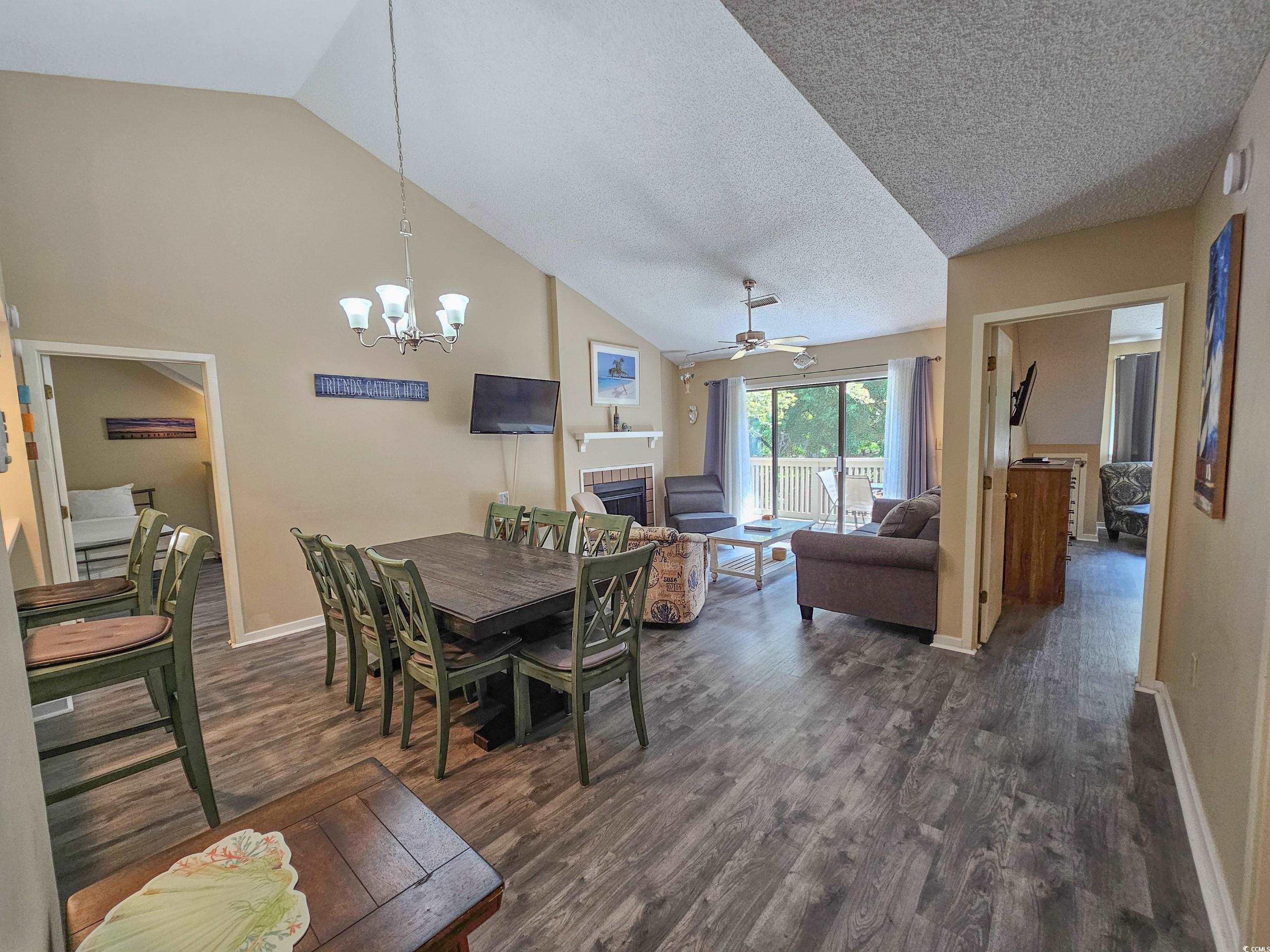 210 Westleton Drive, Unit 13D Myrtle Beach, SC 29572 - Photo 17 of 40 Dining room with vaulted ceiling, dark wood finished floors, baseboards, a chandelier, and ceiling fan