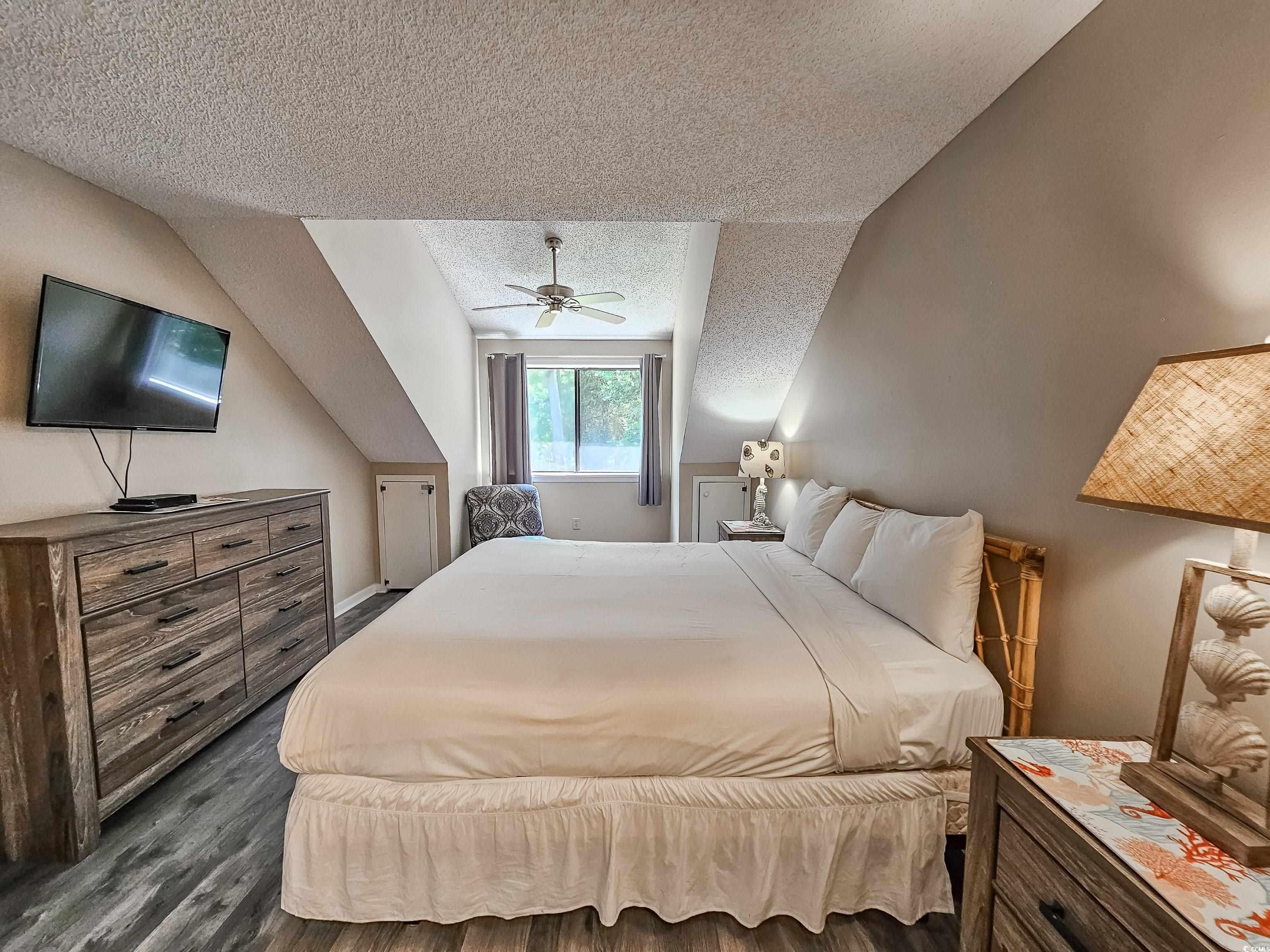 210 Westleton Drive, Unit 13D Myrtle Beach, SC 29572 - Photo 21 of 40 Bedroom with a textured ceiling, dark wood finished floors, ceiling fan, and lofted ceiling