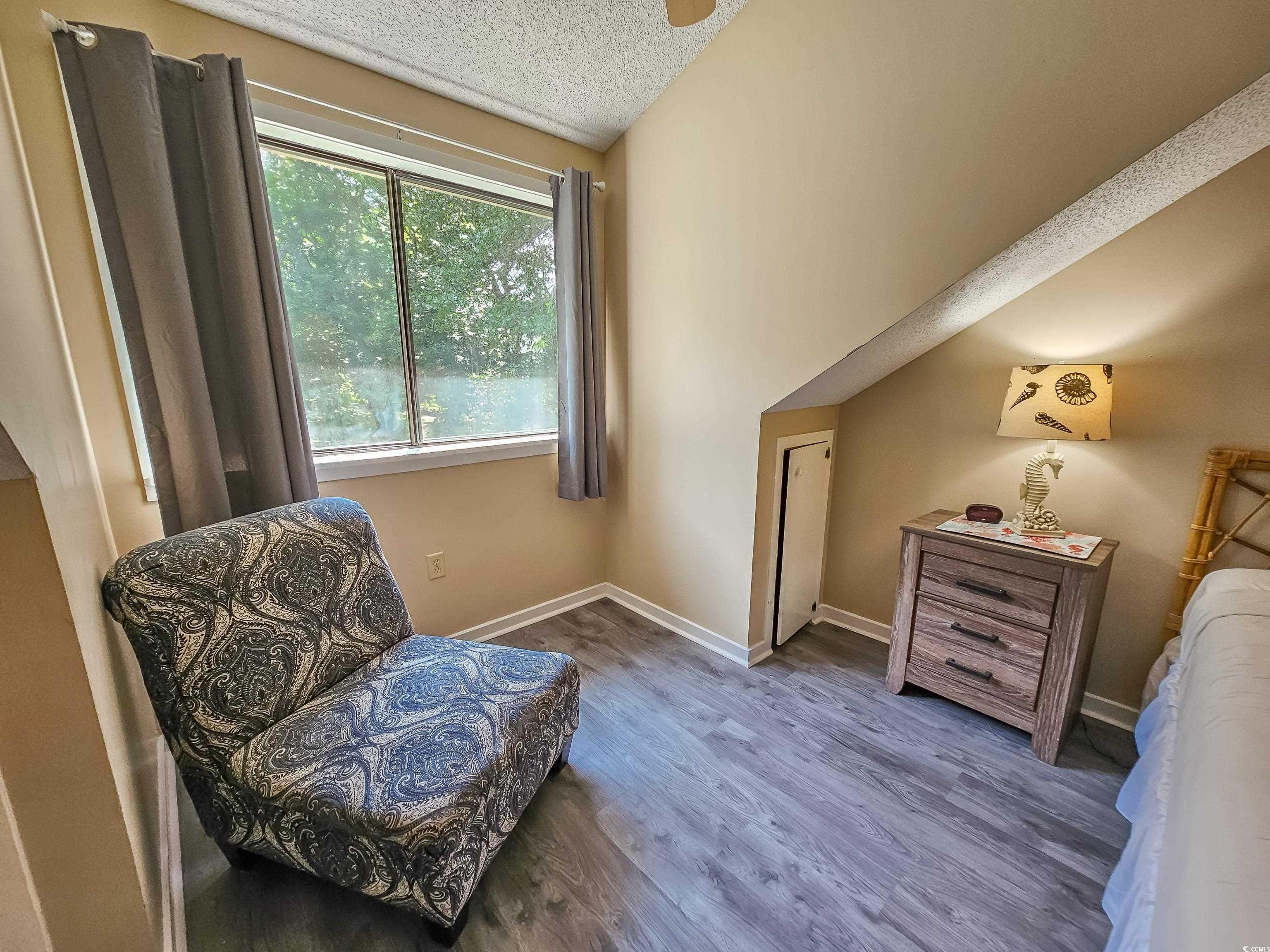 210 Westleton Drive, Unit 13D Myrtle Beach, SC 29572 - Photo 22 of 40 Sitting room with wood finished floors, baseboards, and a textured ceiling