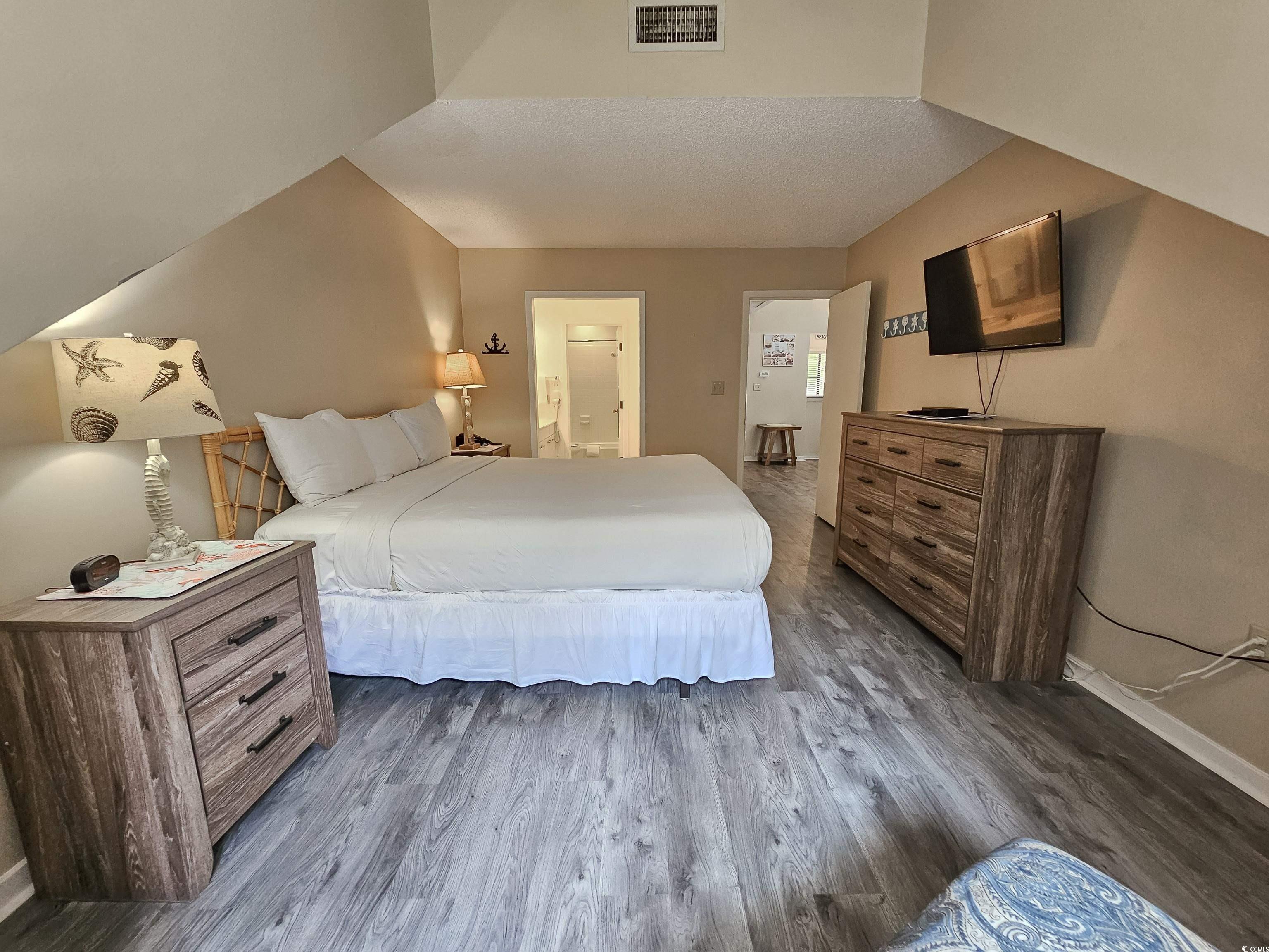 210 Westleton Drive, Unit 13D Myrtle Beach, SC 29572 - Photo 23 of 40 Bedroom with baseboards, dark wood finished floors, and ensuite bath