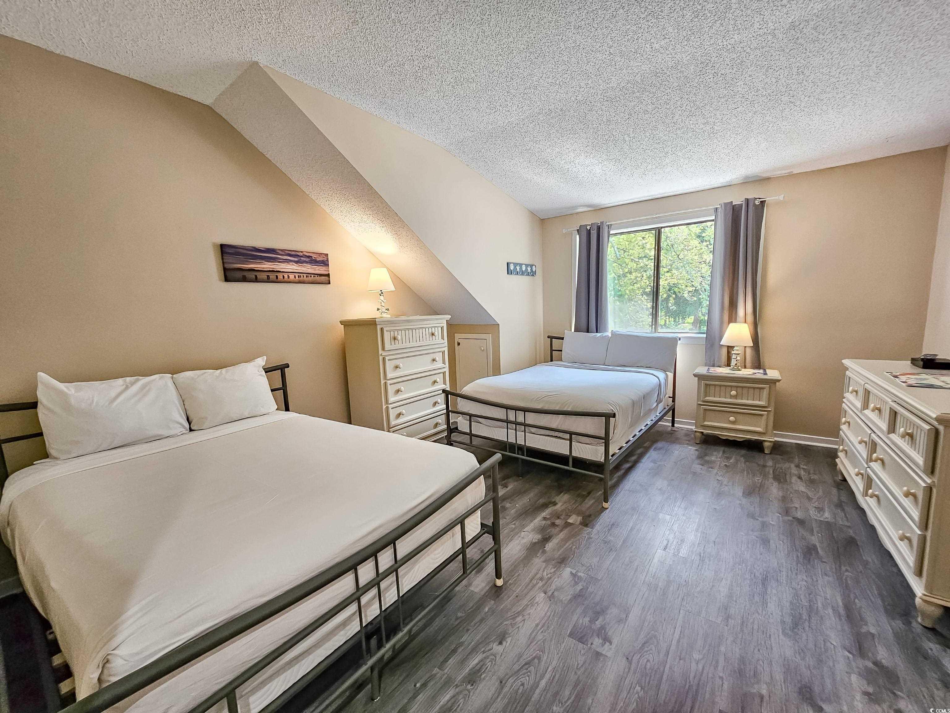 210 Westleton Drive, Unit 13D Myrtle Beach, SC 29572 - Photo 27 of 40 Bedroom with a textured ceiling and dark wood-style floors