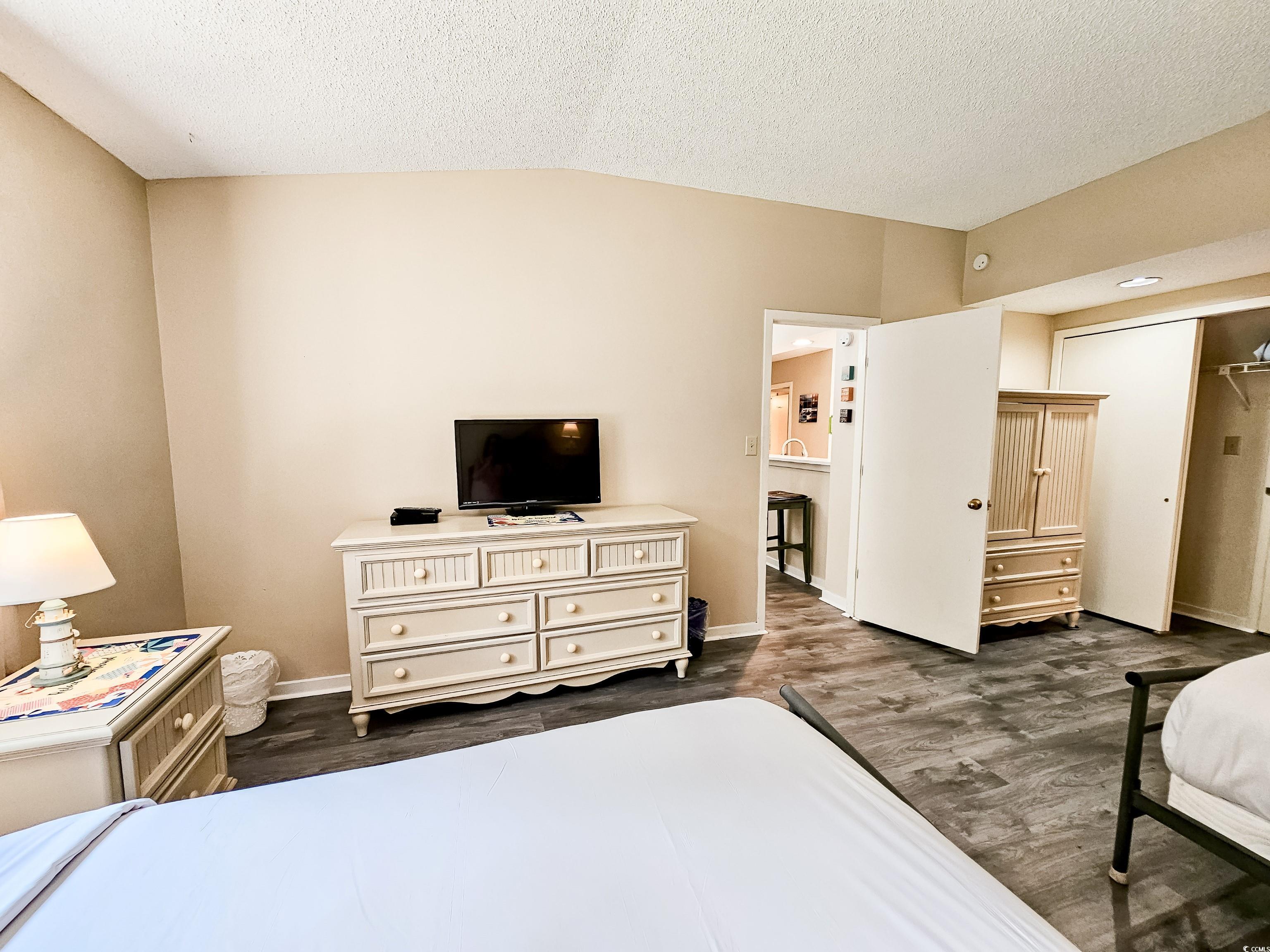 210 Westleton Drive, Unit 13D Myrtle Beach, SC 29572 - Photo 28 of 40 Bedroom with dark wood-type flooring, a textured ceiling, baseboards, and vaulted ceiling