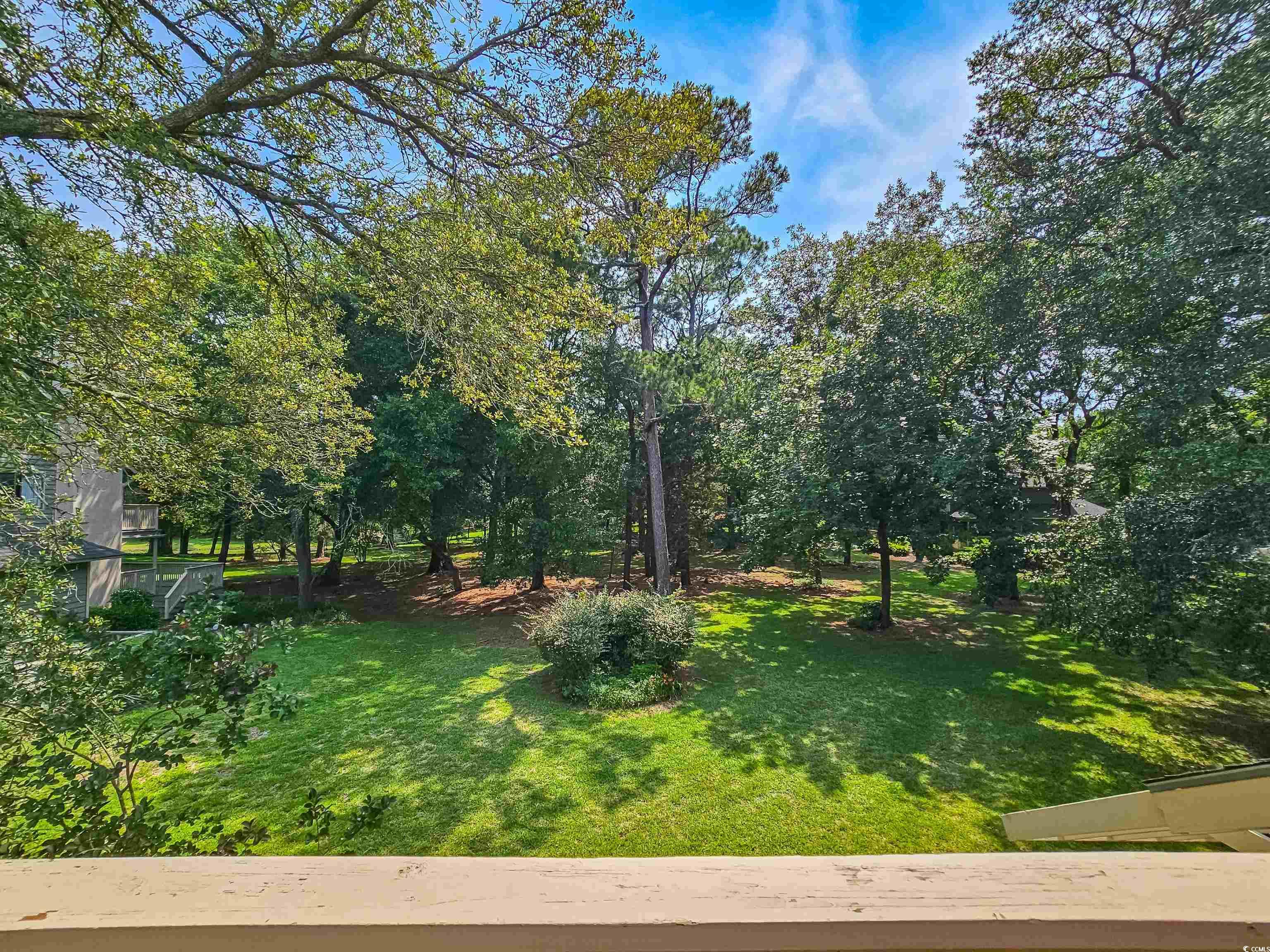 210 Westleton Drive, Unit 13D Myrtle Beach, SC 29572 - Photo 3 of 40 View of grassy yard with view of wooded area