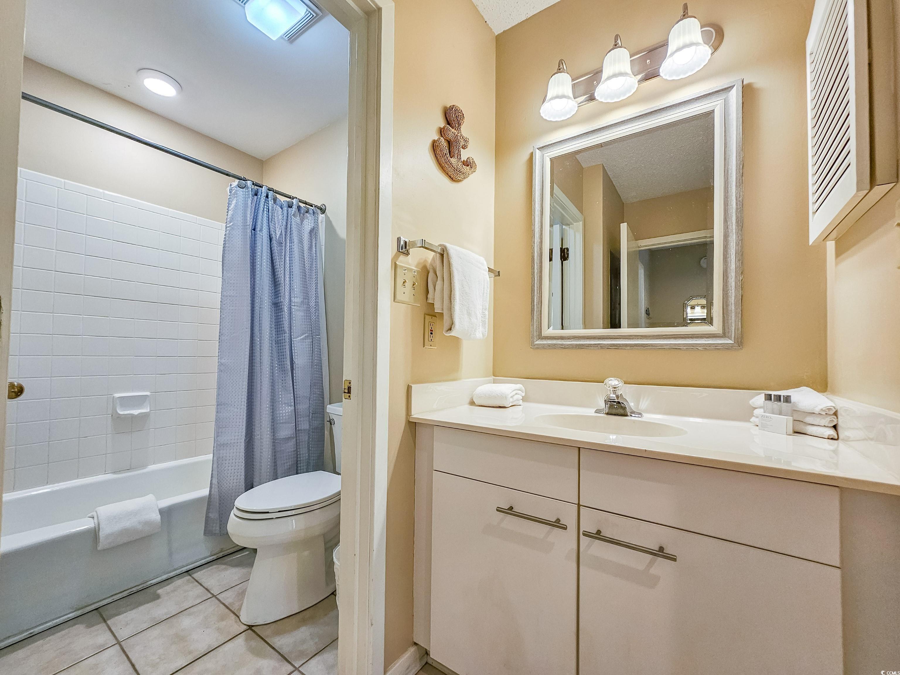 210 Westleton Drive, Unit 13D Myrtle Beach, SC 29572 - Photo 33 of 40 Full bath featuring toilet, tile patterned floors, vanity, and shower / bath combo with shower curtain
