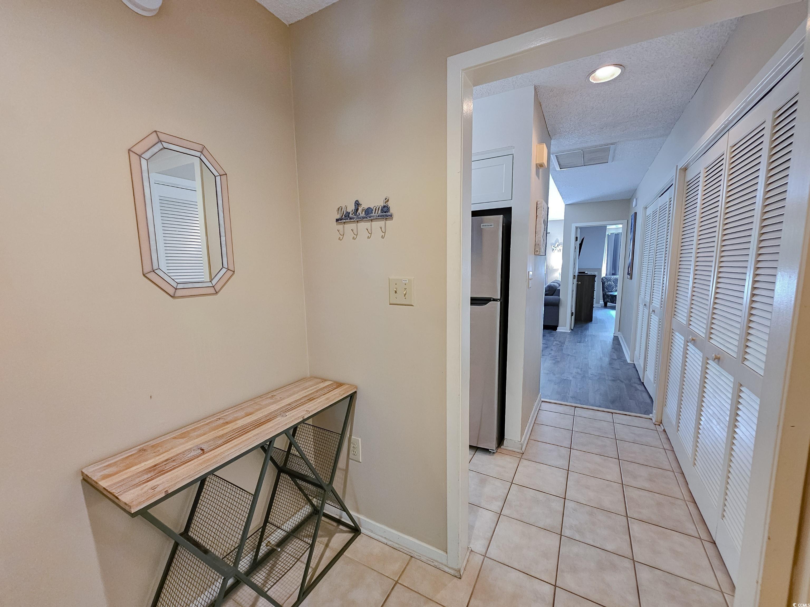 210 Westleton Drive, Unit 13D Myrtle Beach, SC 29572 - Photo 35 of 40 Hallway with light tile patterned flooring and baseboards