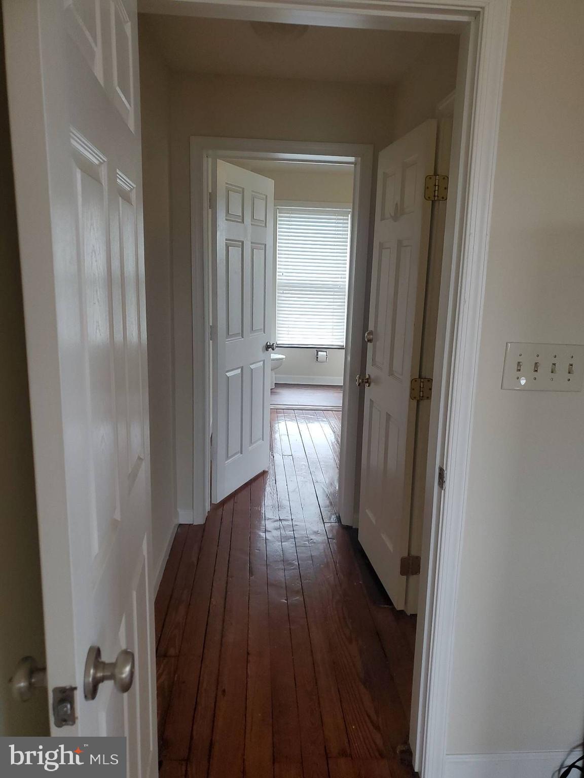 713 West 33rd Street, Unit 3 Baltimore, MD 21211 - Photo 5 of 10 a view of a hallway with wooden floor
