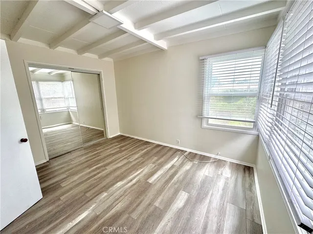 a view of an empty room and wooden floor