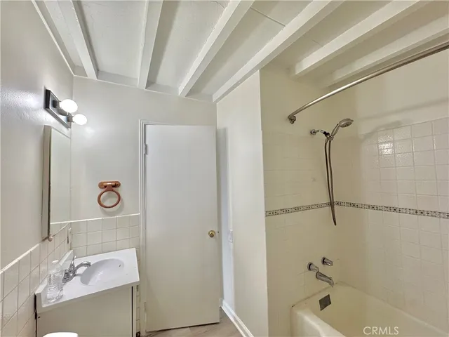 a bathroom with a sink vanity tub and shower