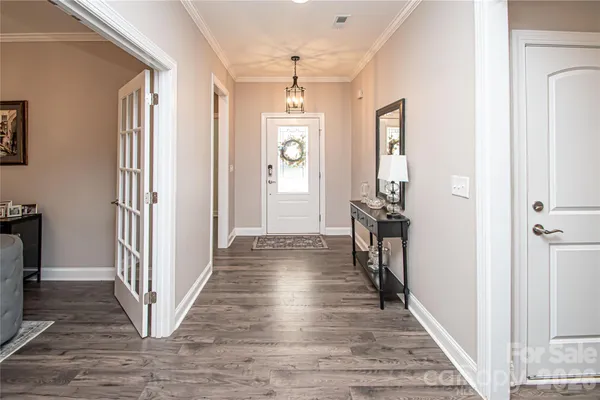 a view of a bedroom from hallway with living room