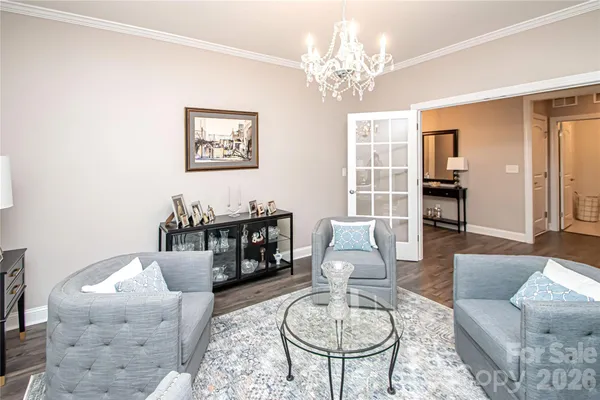 a living room with stainless steel appliances furniture and a flat screen tv