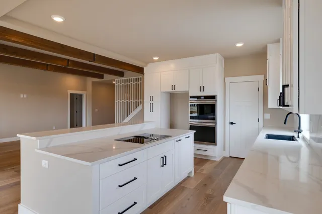 a kitchen with stainless steel appliances a refrigerator and a stove top oven