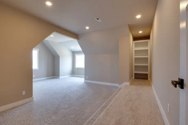 an empty room with closet and wooden door