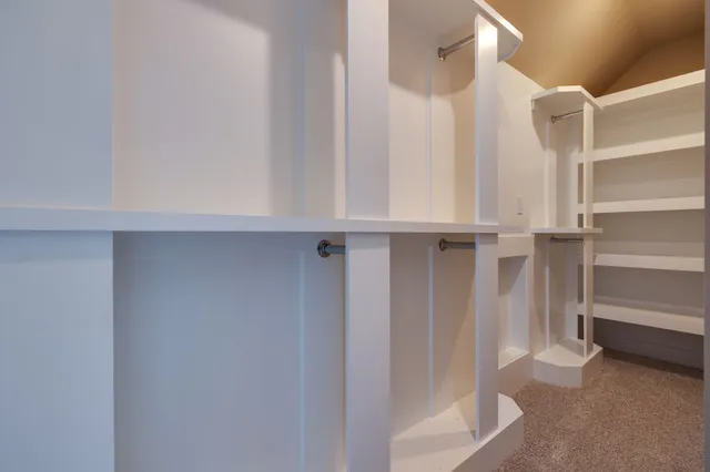 a view of walk in closet with empty racks