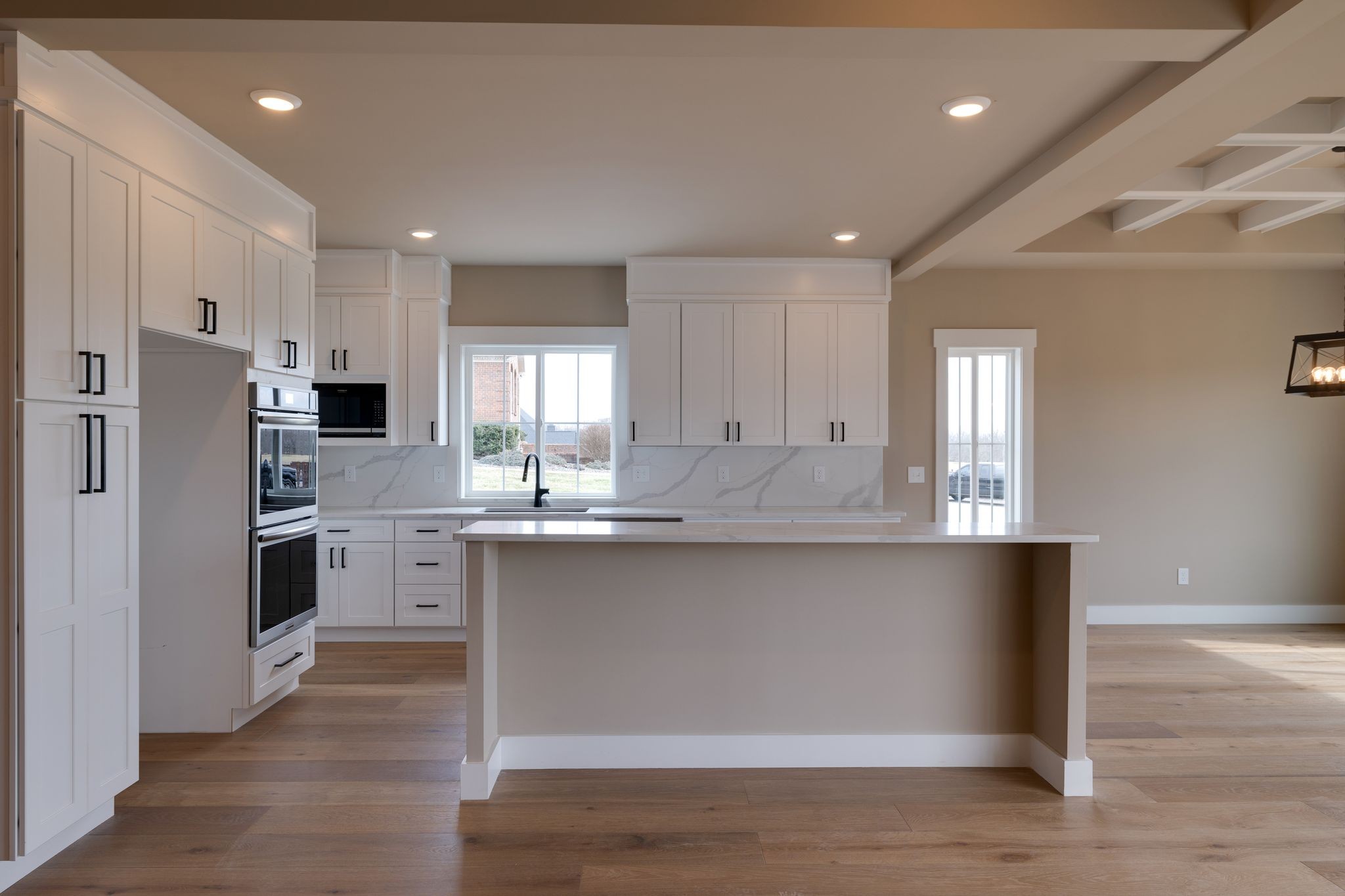 3010 Ora Lane Spring Hill, TN 37174 - Photo 9 of 33 a kitchen with stainless steel appliances granite countertop a refrigerator a sink dishwasher a stove and white cabinets with wooden floor