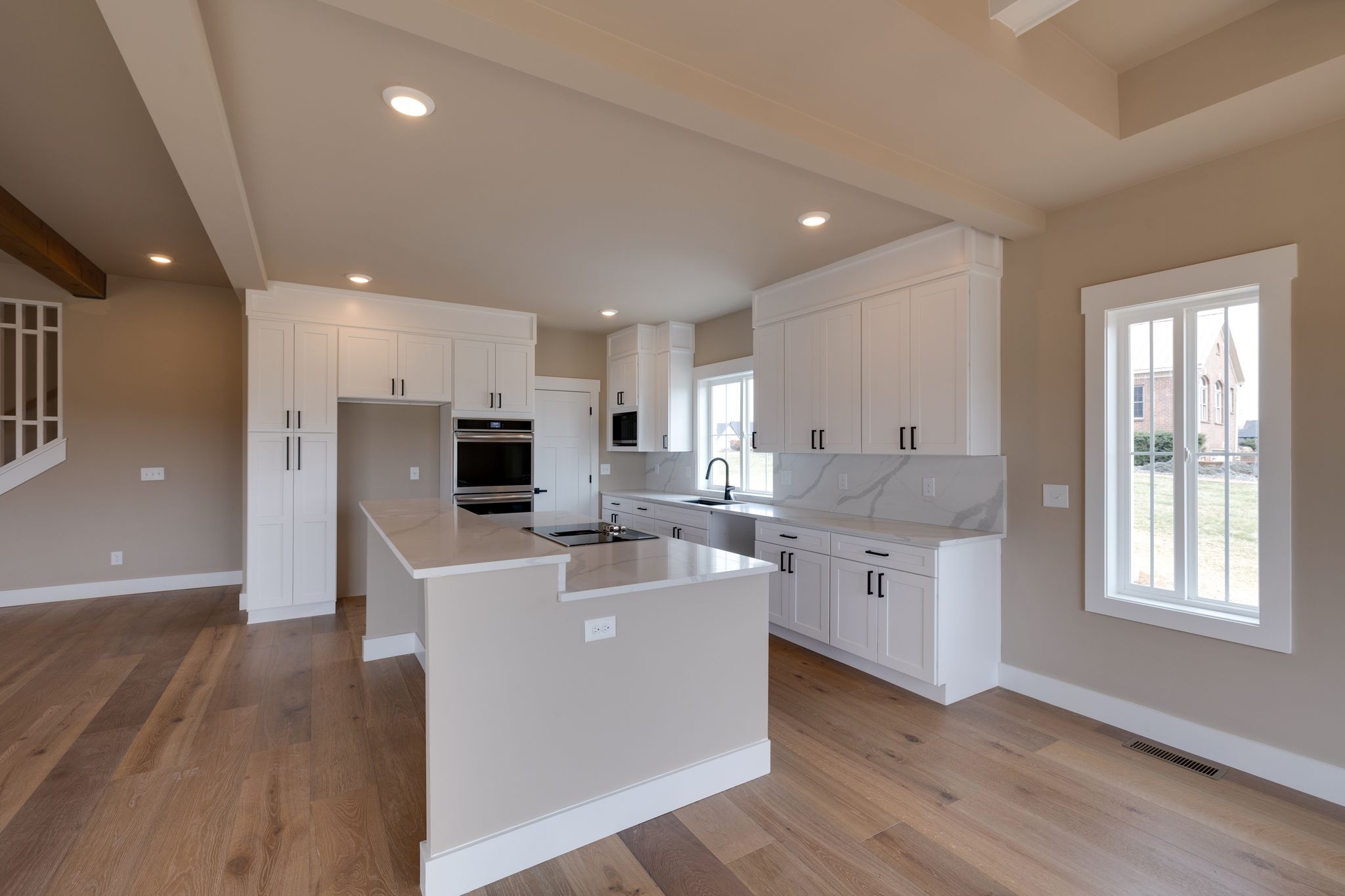 3010 Ora Lane Spring Hill, TN 37174 - Photo 10 of 33 a large white kitchen with stainless steel appliances kitchen island a large counter top and a wooden floors