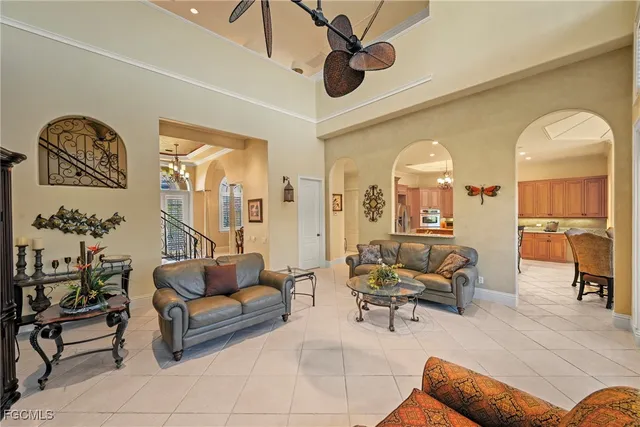 a kitchen with stainless steel appliances granite countertop a stove top oven a refrigerator a sink and chairs